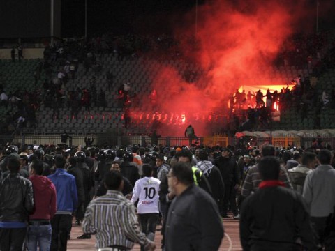 Soccer fans flee from a fire at Port Said Stadium